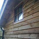 <p>Treated feather edge boarding and spare shingles from roof used to panel under roof eaves</p>